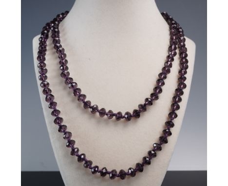 This elegant continuous strand necklace features rich purple faceted beads with exceptional sparkle and depth. Long enough to