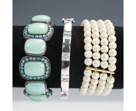 Group of three fashion bracelets in mixed materials and styles. Includes a silver-tone geometric bangle set with five clear s