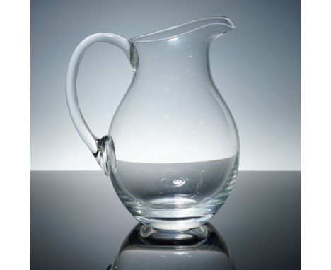 A stunning crystal pitcher by Marquis by Waterford, featuring a gracefully curved silhouette and a generous pouring spout. Th