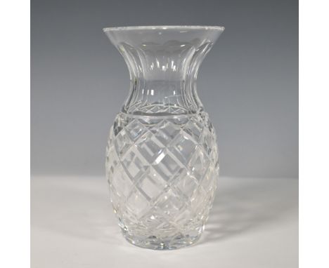 A refined Waterford crystal vase featuring the signature deep diamond cuts and vertical flutes that enhance its brilliance. T