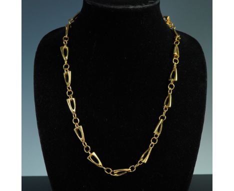 Vintage Trifari necklace in gold tone finish, measuring approximately 24 inches long. Features a distinctive link design char