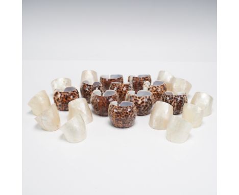 A striking collection of 22 natural shell napkin rings featuring two distinctive organic styles. Included are 10 napkin rings