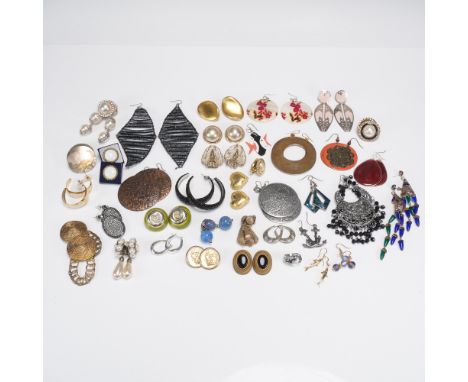 A vibrant and diverse collection of 36 pairs of fashion earrings showcasing a wide array of styles, materials, and eras. This