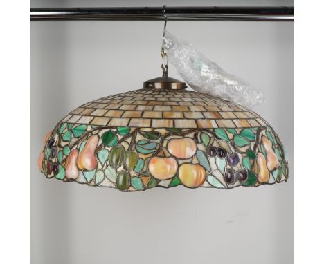 This striking hanging pendant lamp features a richly colored stained glass shade in the classic Tiffany style, showcasing a d