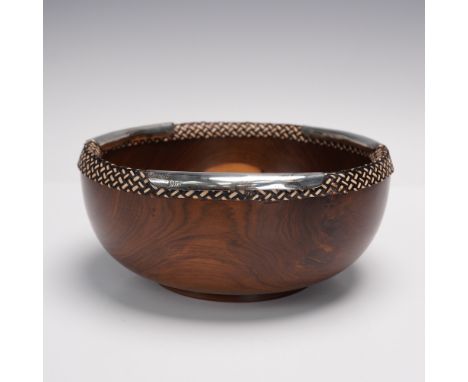 A finely handcrafted wooden bowl by Argenta, featuring richly grained hardwood with a woven fiber rim and sterling silver (.9
