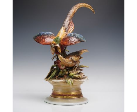 A vibrant and meticulously rendered porcelain sculpture, masterfully capturing the romantic interplay of a pair of golden phe