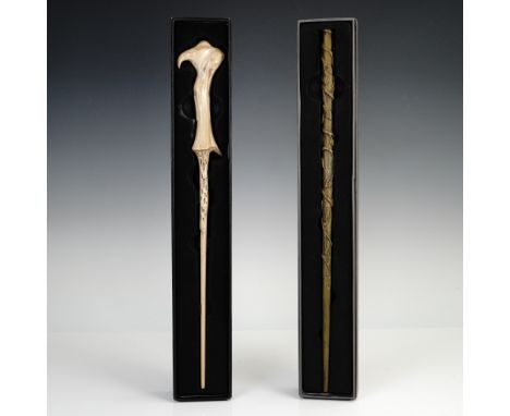 A pair of officially licensed replica wands from The Wizarding World of Harry Potter at Universal Orlando, each housed in its
