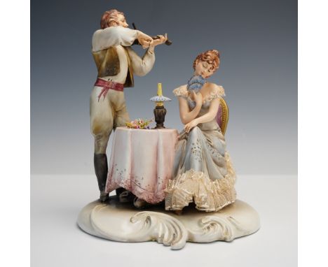 This romantic porcelain figurine by Antonio Borsato captures an enchanting scene of courtship, with a young man serenading a 