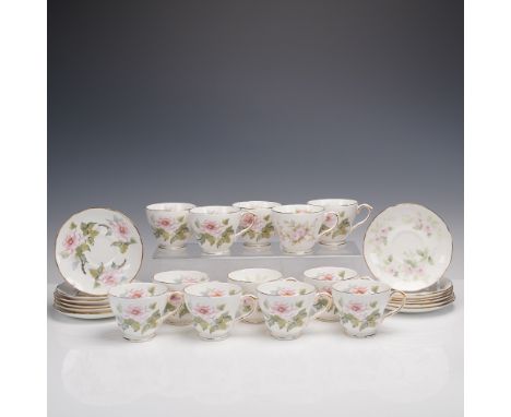 Lovely English bone china tea service by Duchess, featuring twelve matching teacups and twelve saucers. Each piece is adorned