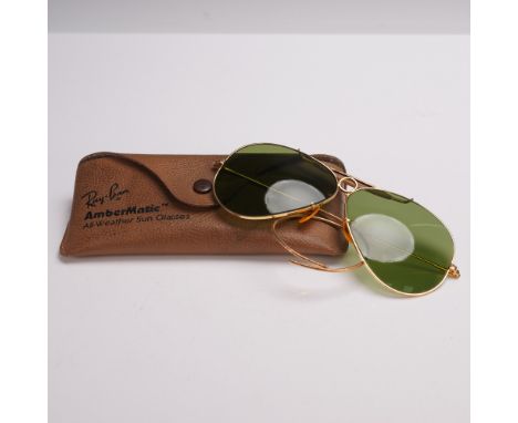 Step into timeless style with these authentic vintage Ray Ban Ambermatic Aviator sunglasses by Bausch and Lomb. Featuring cla