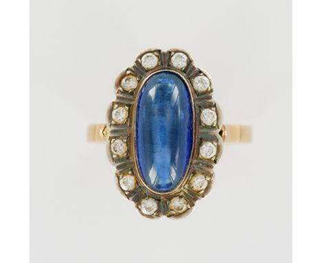An elegant 14k yellow gold ring showcasing a luminous 2.5-carat oval cabochon sapphire of deep cornflower blue hue. The cente