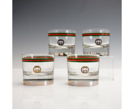 A luxurious 4-piece set of Gucci Italy old fashioned glasses featuring the iconic interlocking GG logo and classic green-red-