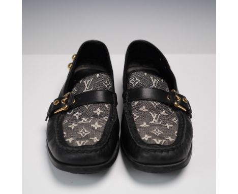 Pair of Louis Vuitton slip-on loafers featuring the brand's iconic monogram canvas panel and smooth black leather trim. The u