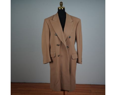 A refined men's overcoat tailored in a rich camel colored lamb wool. This double breasted design features a broad peaked lape