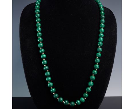 This elegant strand features highly polished green malachite beads, each displaying the stone's signature natural banding. Th