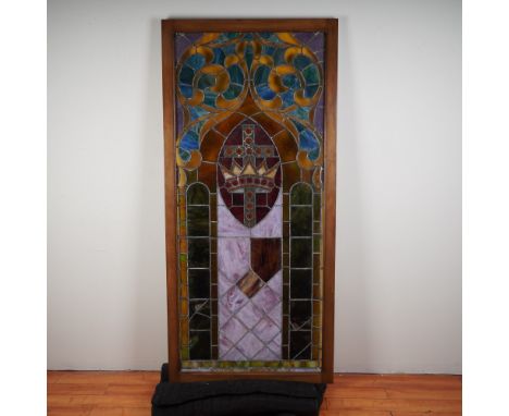 Gorgeous antique stained glass panel featuring a regal crown and cross motif within a lancet arch design. The rich color pale