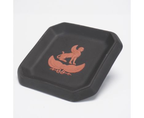 A striking Wedgwood black jasperware dish featuring a finely detailed raised terracotta-colored relief of a winged sphinx abo