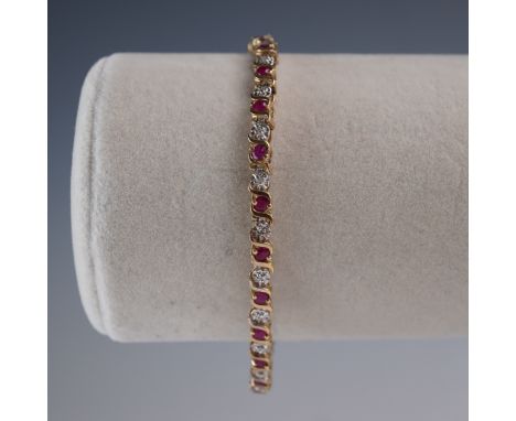 This elegant tennis bracelet features alternating round-cut rubies and diamonds in a sculptural wave-link setting. Each ruby 
