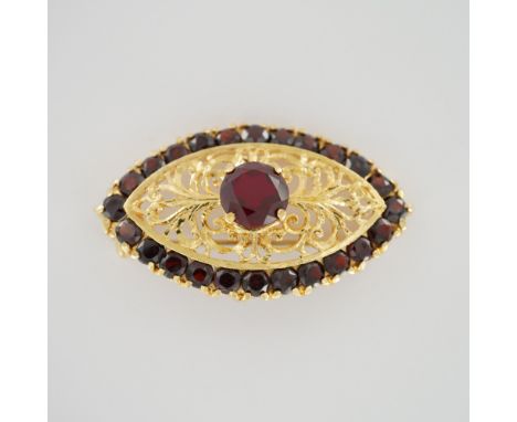 This finely crafted brooch is made of 22kt gold, with an intricate openwork filigree design. Though stamped "750" on the reve