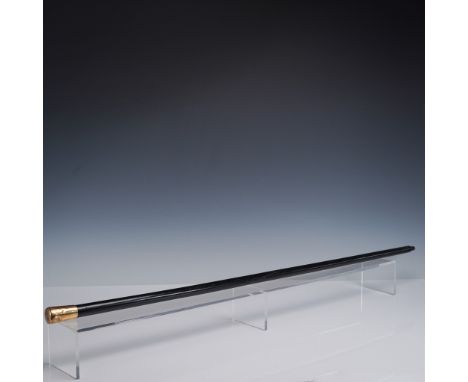 A distinguished antique walking stick featuring a glossy black lacquered wooden shaft and a rounded 4K gold handle. The handl