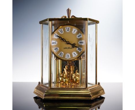 This elegant Seth Thomas anniversary clock, model number 0793-000, showcases a polished gold-tone glass case with beveled edg