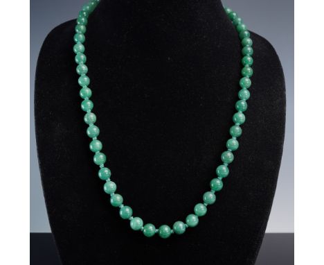 This elegant necklace showcases polished green aventurine beads, each individually hand-knotted on coordinating green cord fo