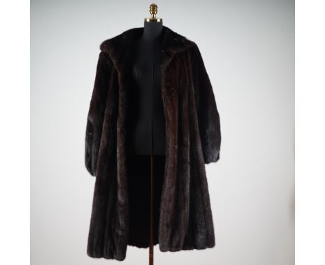 This luxurious full-length mink fur coat by Alaskan Custom Built Furs, Kansas City, showcases a rich dark chocolate brown hue