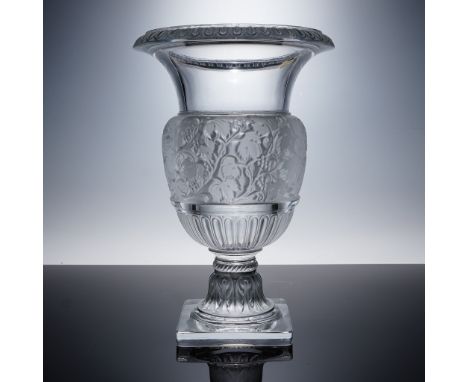This Lalique France Vase Versailles features intricate frosted floral reliefs, a fluted lower body, and a wide, flared rim wi
