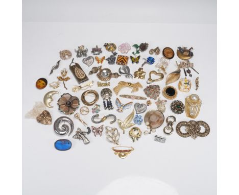 A charming and diverse vintage jewelry lot featuring over 50 unique brooches in a wide range of styles, metals, and motifs. T