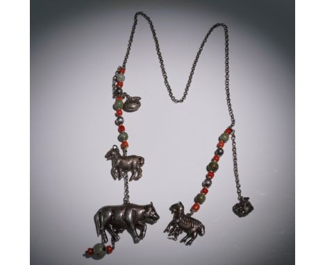 This eclectic beaded strand features detailed cast metal animal and fish charms, including yak, ram, horse, and aquatic motif