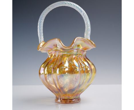 A hand-blown Fenton carnival glass basket featuring an iridescent amber body with deeply swirled ribbing and a clear twisted 