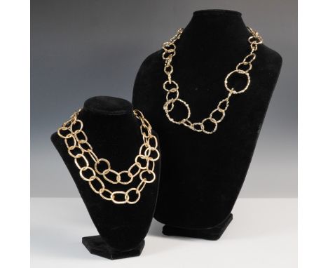 Two-piece set of bold gold tone link necklaces featuring textured, hammered finishes. One necklace is designed with a double 