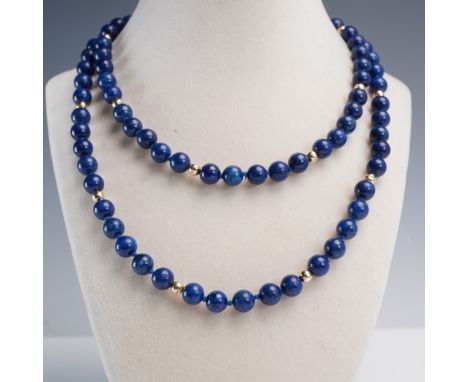 Elegant beaded necklace featuring deep blue lapis lazuli spheres, richly colored with natural flecks and variation. The lapis