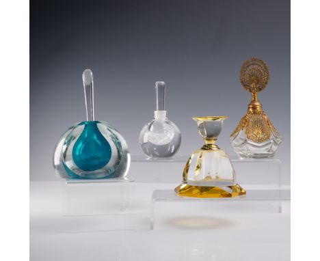 This lot includes four distinctive art glass perfume bottles, each featuring a unique stopper and decorative style. The colle