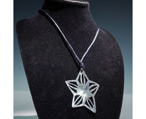 This sculptural star-shaped pendant is crafted in sterling silver and marked 925 LIZ 2000 on the reverse. Featuring an openwo