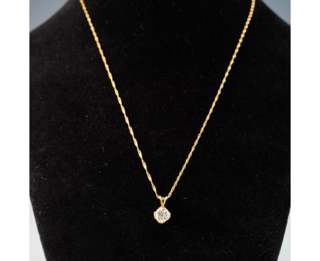 A refined 14k yellow gold pendant necklace featuring a bright, brilliant-cut stone prong-set in a sculptural claw-style mount
