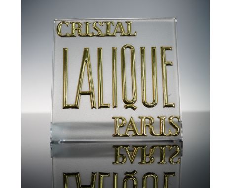 This Lalique crystal display plaque features raised and gilded lettering reading Cristal Lalique Paris, rendered in striking 