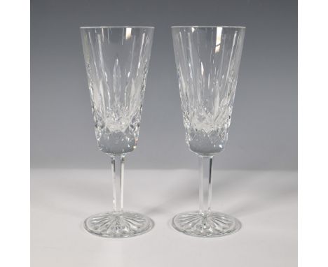 A pair of elegant Waterford crystal champagne flutes in the iconic Lismore pattern, each measuring 7.25"H. Featuring intricat