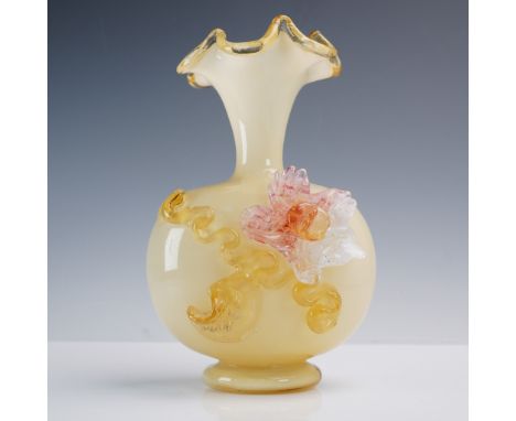 This charming hand blown art glass vase features a rounded body in soft golden-amber with applied floral and ribbon-like deco