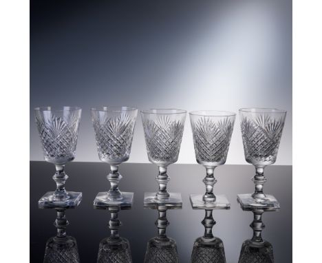 A dazzling set of five cut crystal claret wine glasses by renowned American firm T.G. Hawkes &amp; Co., each executed in the 