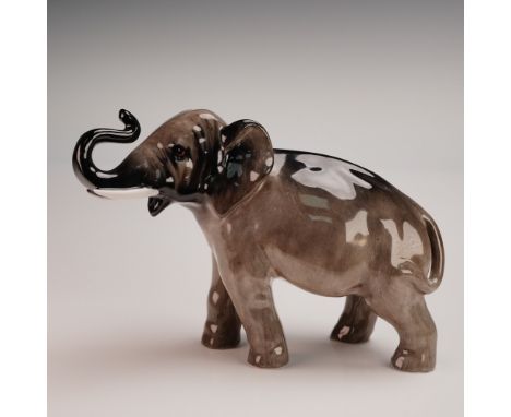 This Royal Doulton porcelain elephant figurine, model HN2644, features a beautifully hand painted high gloss finish in rich b