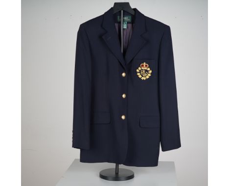 A classic navy wool blazer, tailored in a traditional equestrian inspired silhouette. This structured single breasted jacket 