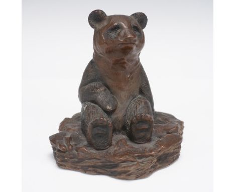 Charming and emotive, this limited edition bronze sculpture by American artist Floyd DeWitt depicts a seated bear with upward