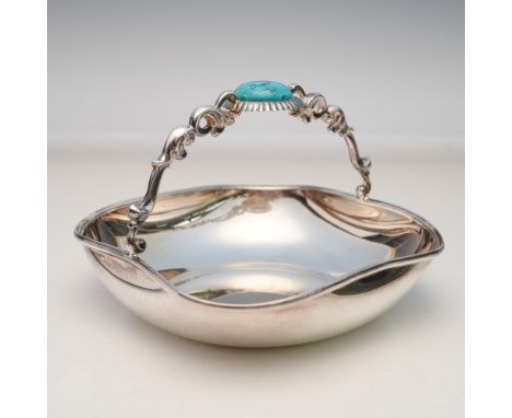Peruvian sterling silver handled basket crafted by Camusso. The shallow circular bowl features a smooth polished surface and 