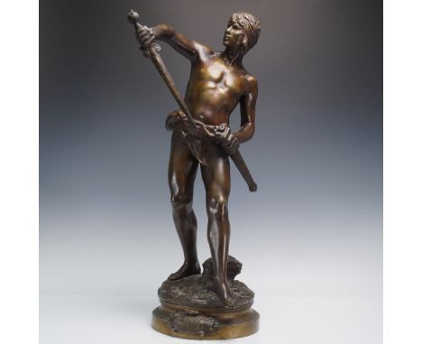A finely cast bronze sculpture depicting a youthful warrior in a moment of poised readiness, rendered with classical proporti