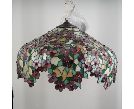 A breathtaking floral-themed hanging chandelier composed of richly colored stained glass in a Tiffany-style motif. This handc