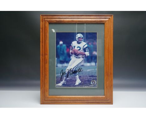 A framed and matted autographed photo of legendary New York Jets quarterback Joe Namath. The photograph captures Namath in ac