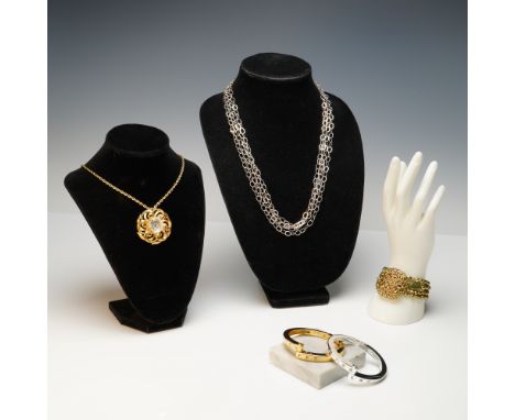 A collection of five fashion jewelry pieces including two necklaces and three bracelets. One necklace features an ornate gold