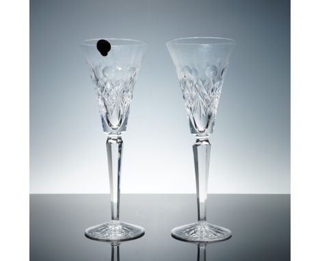 Pair of clear cut crystal toasting flutes manufactured by Waterford Crystal for Walt Disney. Each flute features a faceted st