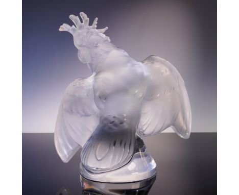 A majestic cockatoo figurine by Lalique, France, showcasing the house's hallmark combination of frosted and clear crystal. Th